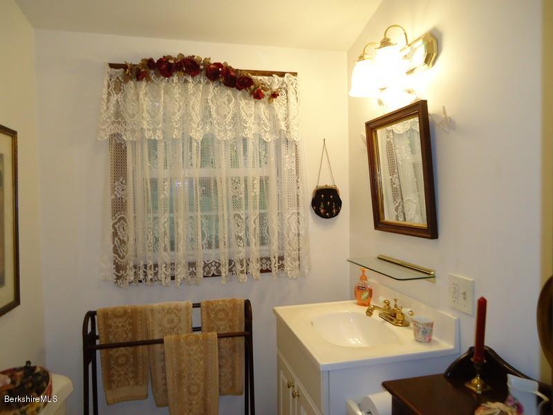2359 North Main Road Otis, MA 01253 - Photo 23 of 32 a bathroom with a sink and a mirror
