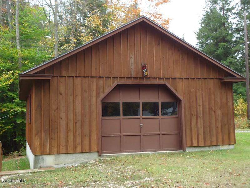 2359 North Main Road Otis, MA 01253 - Photo 4 of 32 a house with a small yard