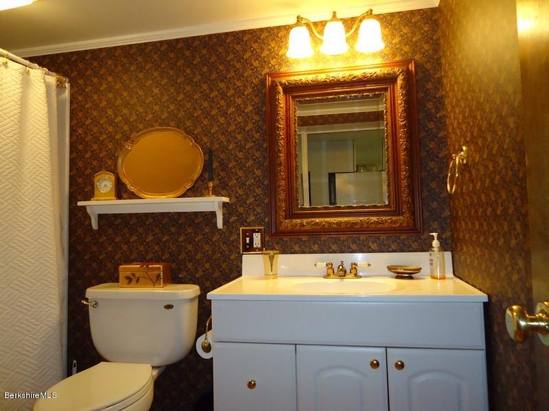 2359 North Main Road Otis, MA 01253 - Photo 31 of 32 a bathroom with a toilet sink and mirror
