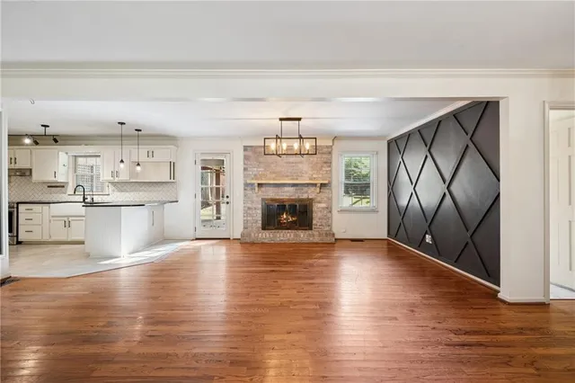 a view of a kitchen with cabinets and wooden floor