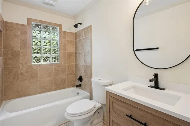 a bathroom with a sink a mirror a toilet and a bathtub