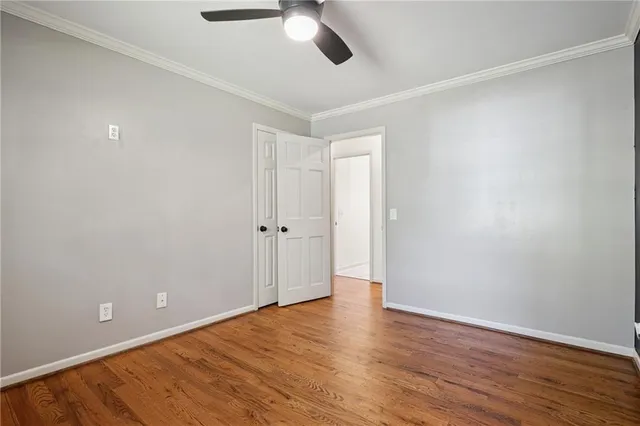 a picture of a room with a white wall and a window