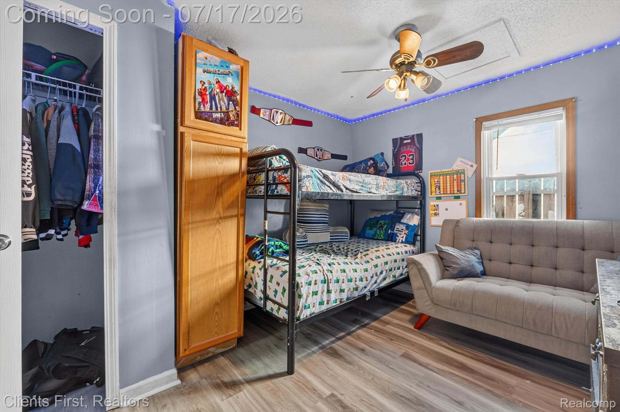 36852 Chase Street Romulus, MI 48174 - Photo 23 of 40 Room with wood-finish flooring, a ceiling fan with integrated lighting, and a window featuring wood trim