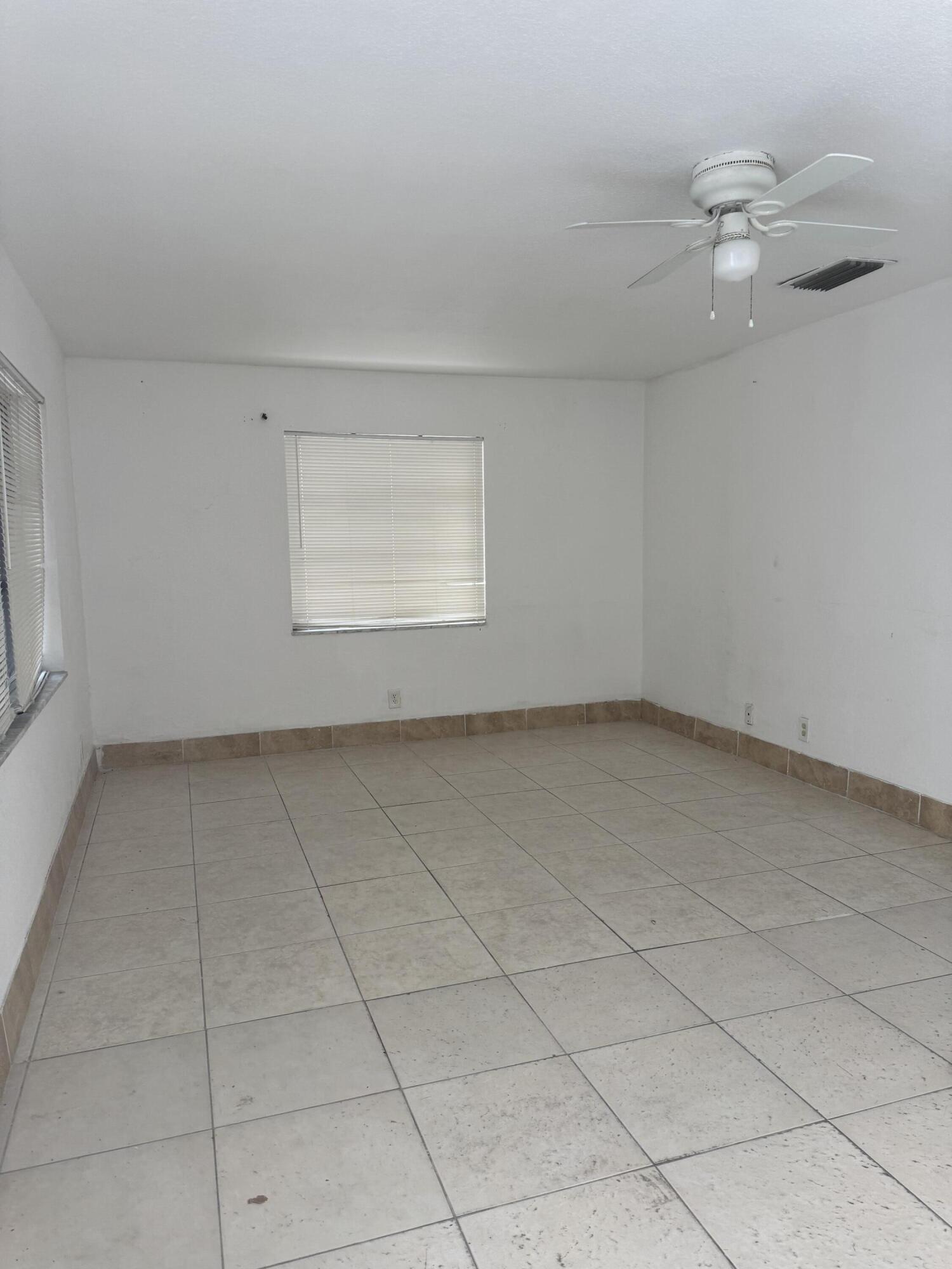 3500 Riverside Drive, Unit 13 Coral Springs, FL 33065 - Photo 15 of 15 an empty room with a empty space and windows