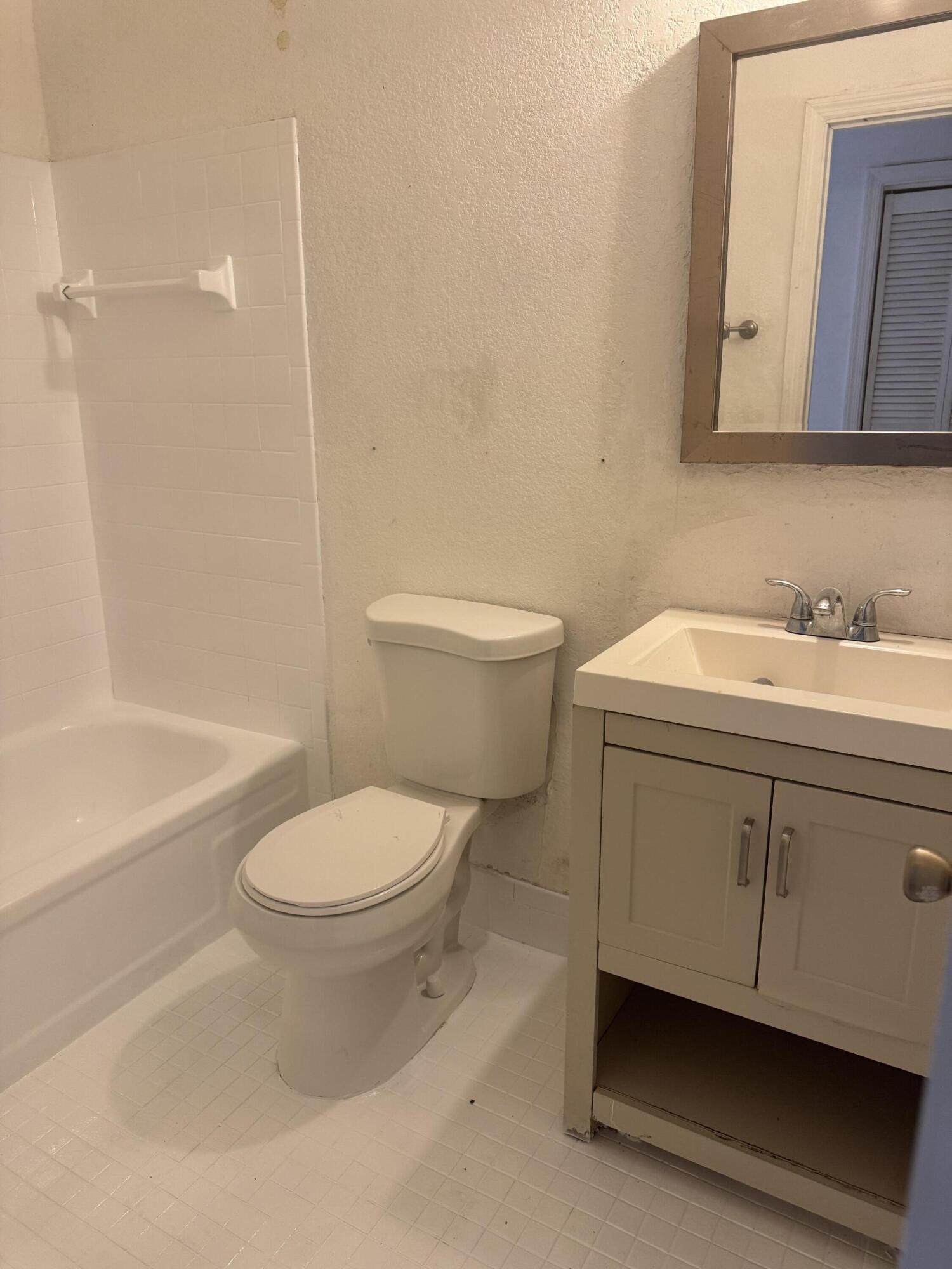 3500 Riverside Drive, Unit 13 Coral Springs, FL 33065 - Photo 7 of 15 a bathroom with a sink a toilet and shower