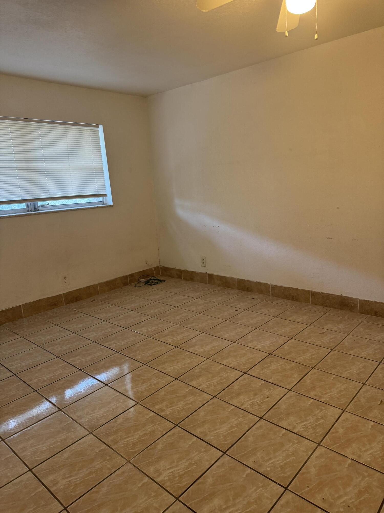 3500 Riverside Drive, Unit 13 Coral Springs, FL 33065 - Photo 9 of 15 a view of an empty room and wooden floor