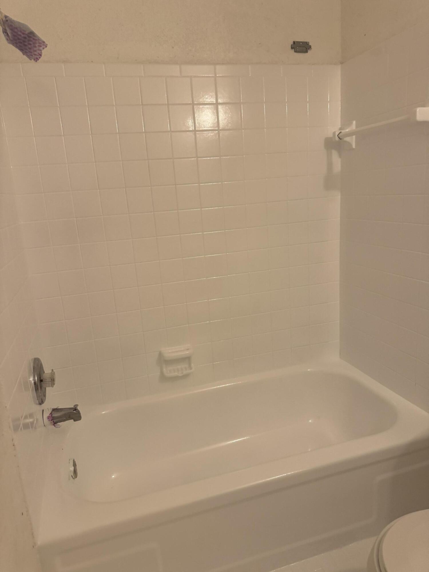 3500 Riverside Drive, Unit 13 Coral Springs, FL 33065 - Photo 10 of 15 a close up of a bathtub in a bathroom