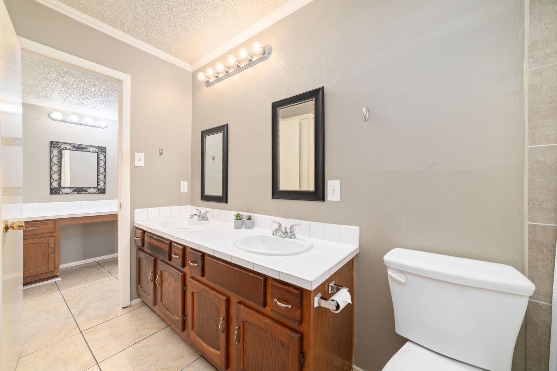 25402 Mill Pond Lane Spring, TX 77373 - Photo 11 of 22 a bathroom with a sink a toilet and mirror