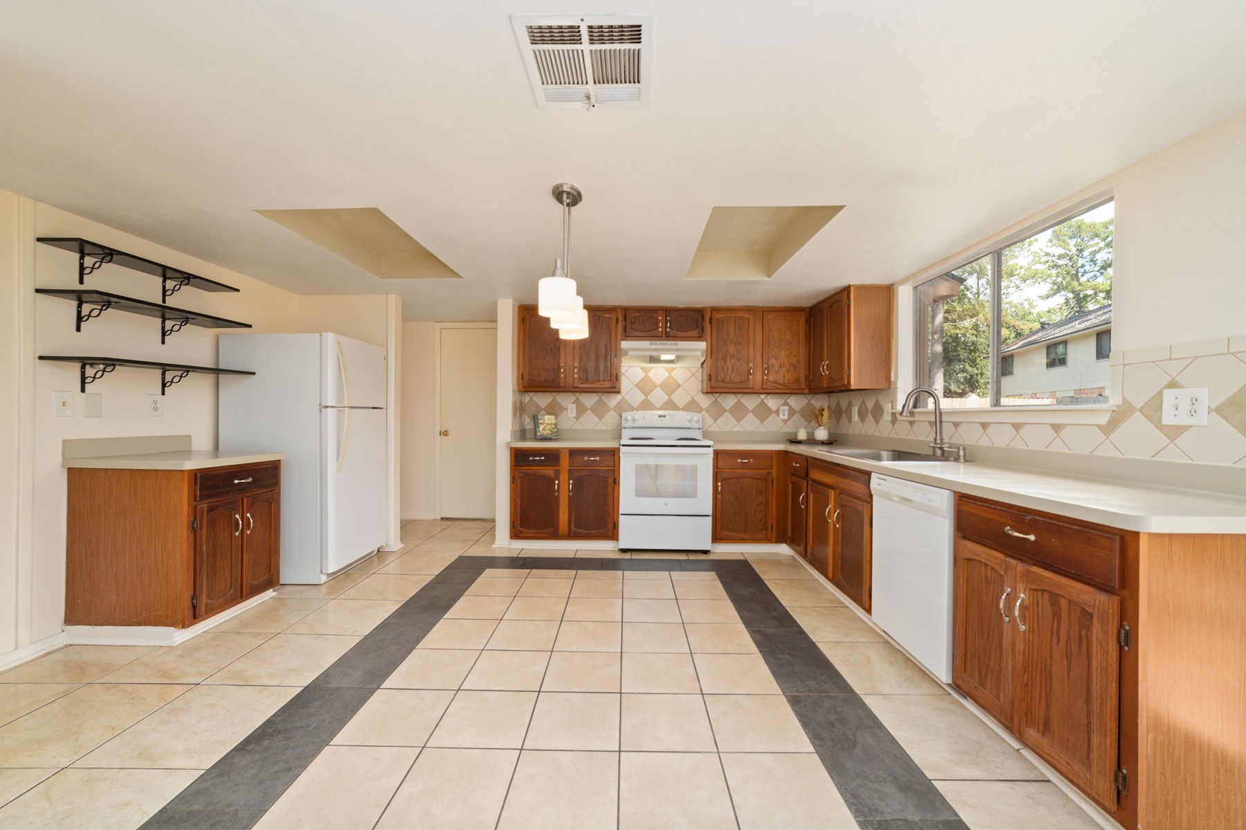 25402 Mill Pond Lane Spring, TX 77373 - Photo 12 of 22 a large kitchen with cabinets and stainless steel appliances