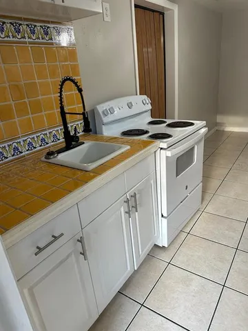 a close view of a sink a washer and dryer