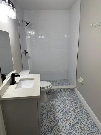 a bathroom with a sink toilet and shower