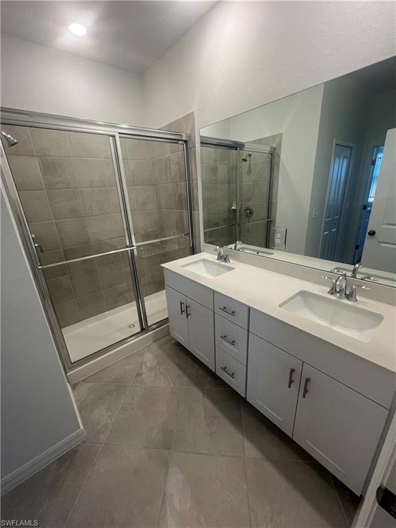 2971 Citrus Street Naples, FL 34120 - Photo 17 of 42 a spacious bathroom with a double vanity sink and a mirror