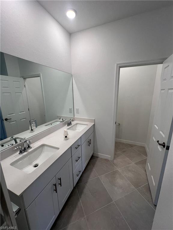 2971 Citrus Street Naples, FL 34120 - Photo 18 of 42 a spacious bathroom with a double vanity sink and mirror