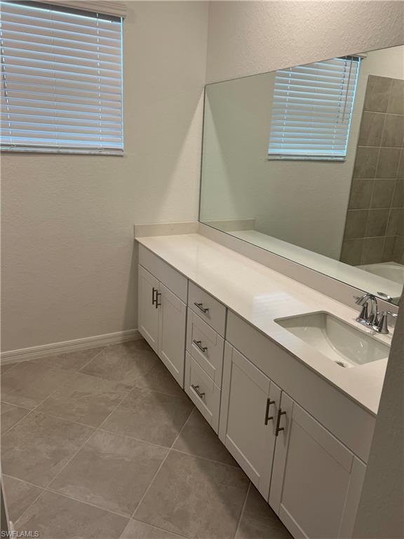 2971 Citrus Street Naples, FL 34120 - Photo 24 of 42 a bathroom with a sink and a mirror