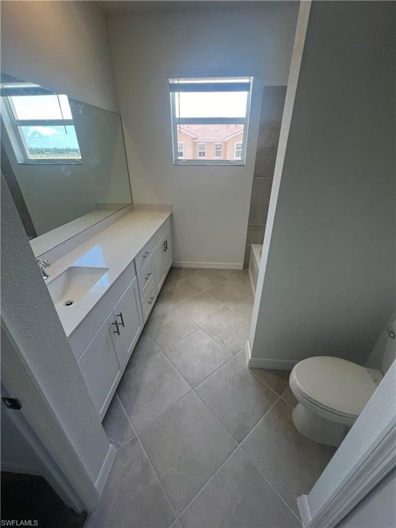 2971 Citrus Street Naples, FL 34120 - Photo 26 of 42 a bathroom with a toilet sink and mirror