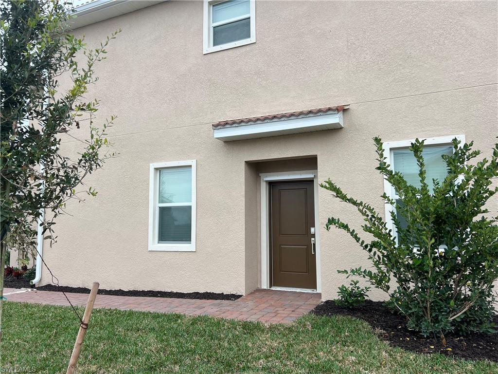 2971 Citrus Street Naples, FL 34120 - Photo 3 of 42 a front view of a house with a yard