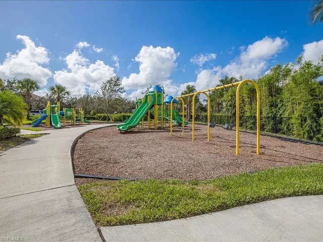a view of outdoor space with playground and green space