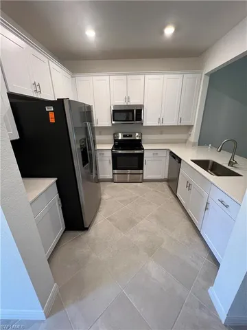 a view of a livingroom with wooden floor and windows
