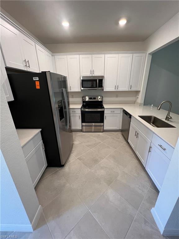 2971 Citrus Street Naples, FL 34120 - Photo 7 of 42 a kitchen with granite countertop a refrigerator sink and cabinets