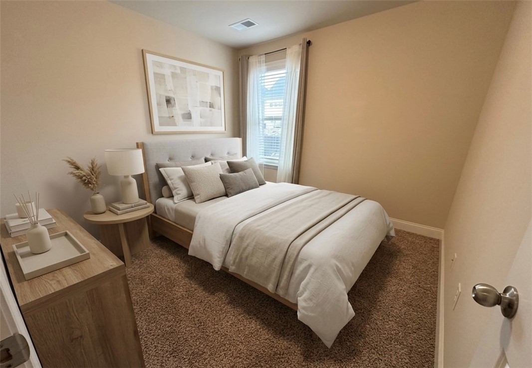874 Wild Orchard Lane Woodruff, SC 29388 - Photo 11 of 12 This cozy bedroom features warm tones, soft carpet, and natural light, creating a serene and inviting atmosphere. Virtually staged room.