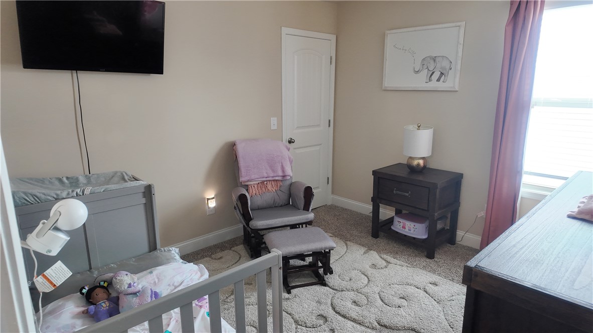 874 Wild Orchard Lane Woodruff, SC 29388 - Photo 12 of 12 This cozy bedroom offers a tranquil retreat with soft lighting and comfortable carpeting.