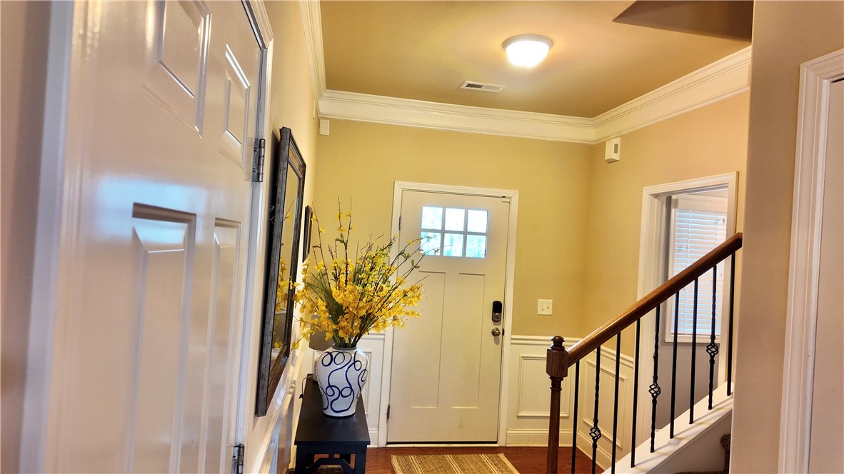 874 Wild Orchard Lane Woodruff, SC 29388 - Photo 2 of 12 An inviting entry showcases classic design elements and rich hardwood floors.