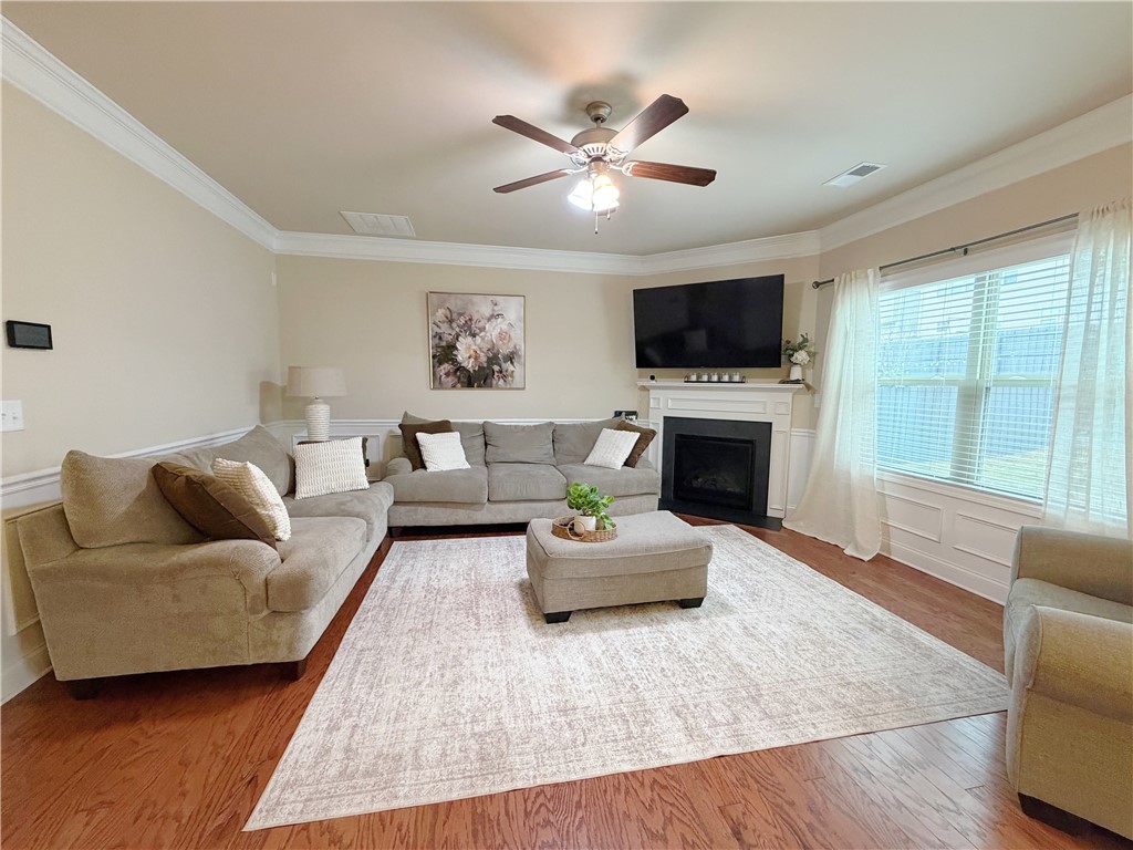 874 Wild Orchard Lane Woodruff, SC 29388 - Photo 3 of 12 This inviting living space features rich hardwood floors and a cozy fireplace.