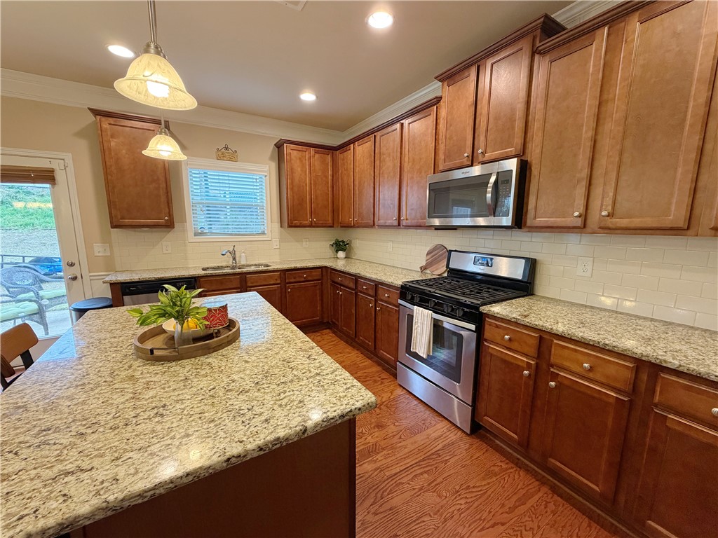 874 Wild Orchard Lane Woodruff, SC 29388 - Photo 5 of 12 This spacious kitchen offers ample granite counter space and rich wood cabinetry for culinary endeavors.