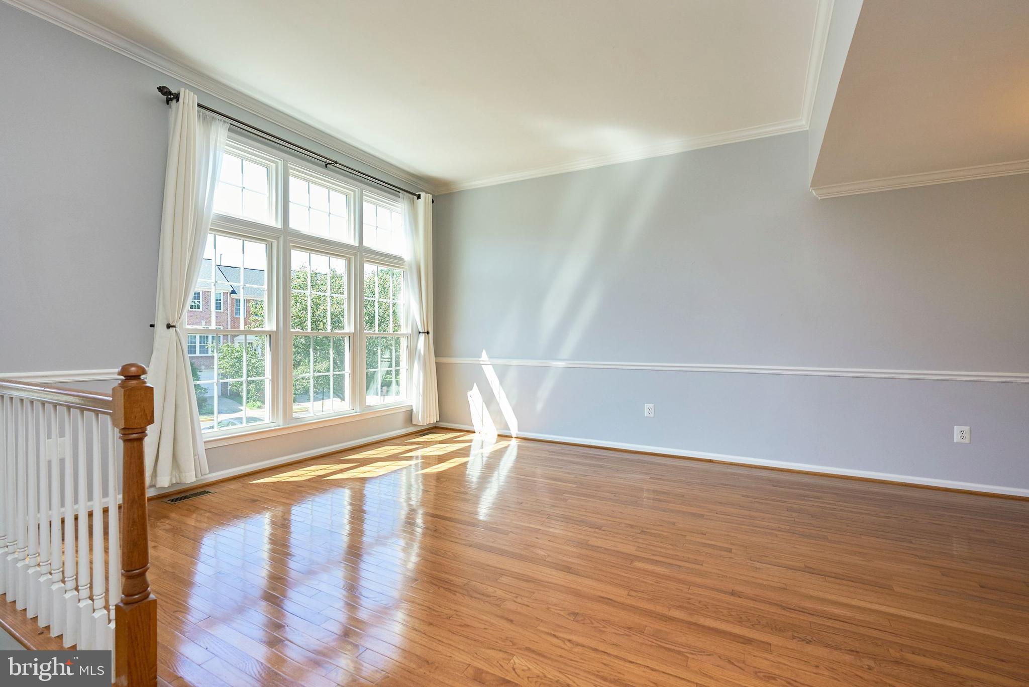 20340 Brentmeade Terrace Sterling, VA 20165 - Photo 11 of 43 a view of an empty room with wooden floor and a window