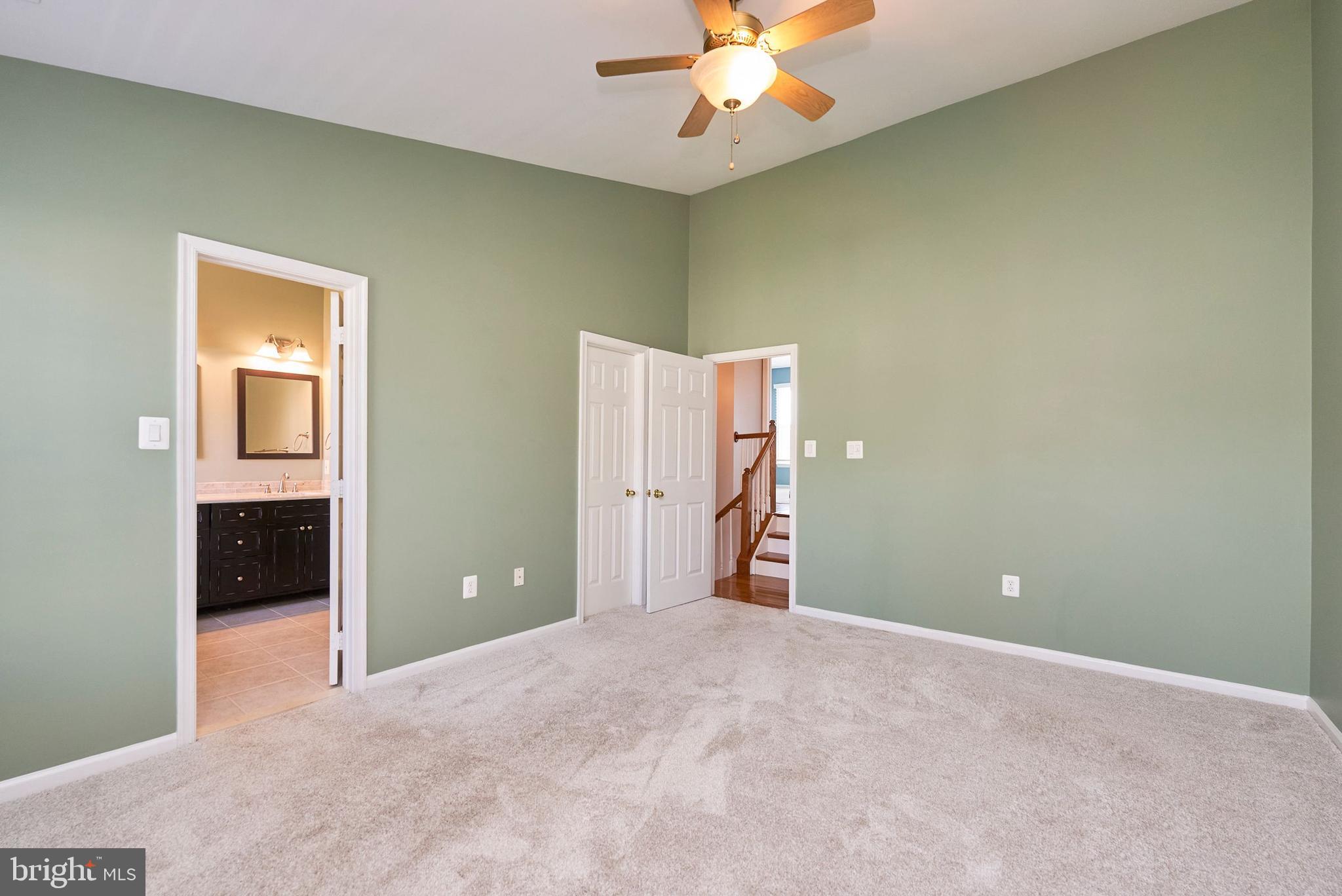 20340 Brentmeade Terrace Sterling, VA 20165 - Photo 14 of 43 a view of a room with a chandelier fan and a bathroom