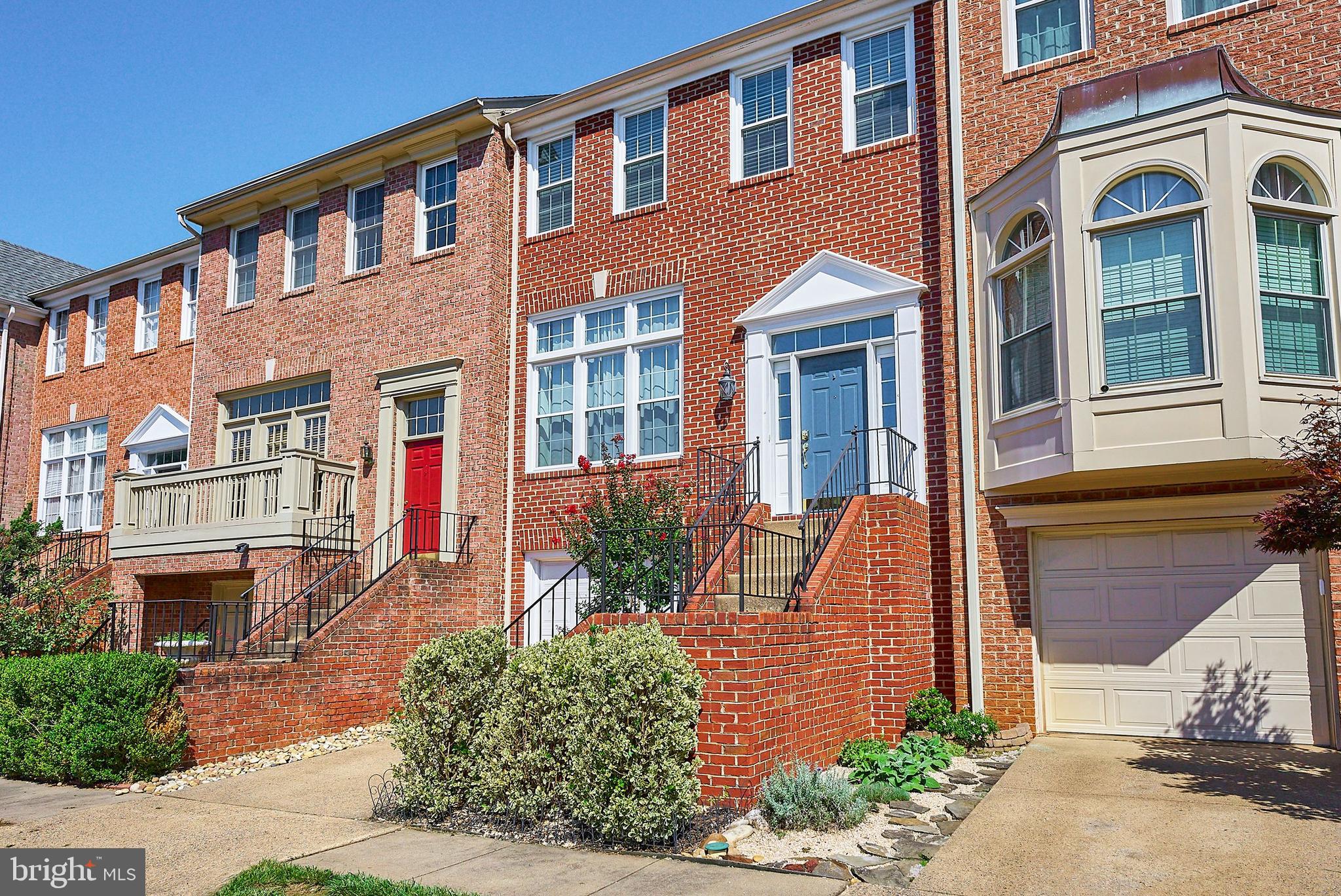 20340 Brentmeade Terrace Sterling, VA 20165 - Photo 31 of 43 front view of a brick house with a yard