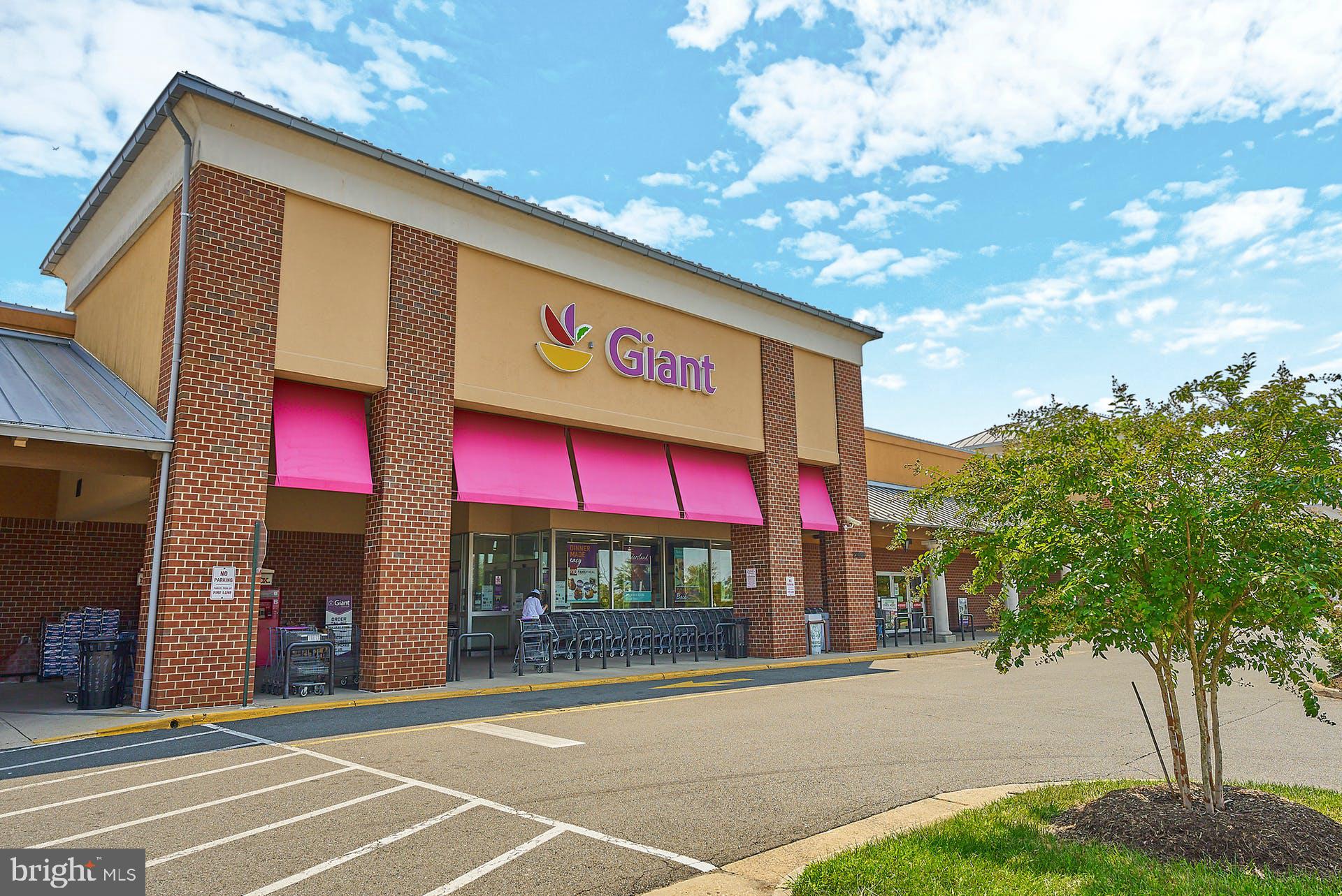 20340 Brentmeade Terrace Sterling, VA 20165 - Photo 36 of 43 a view of a brick building with a large tree