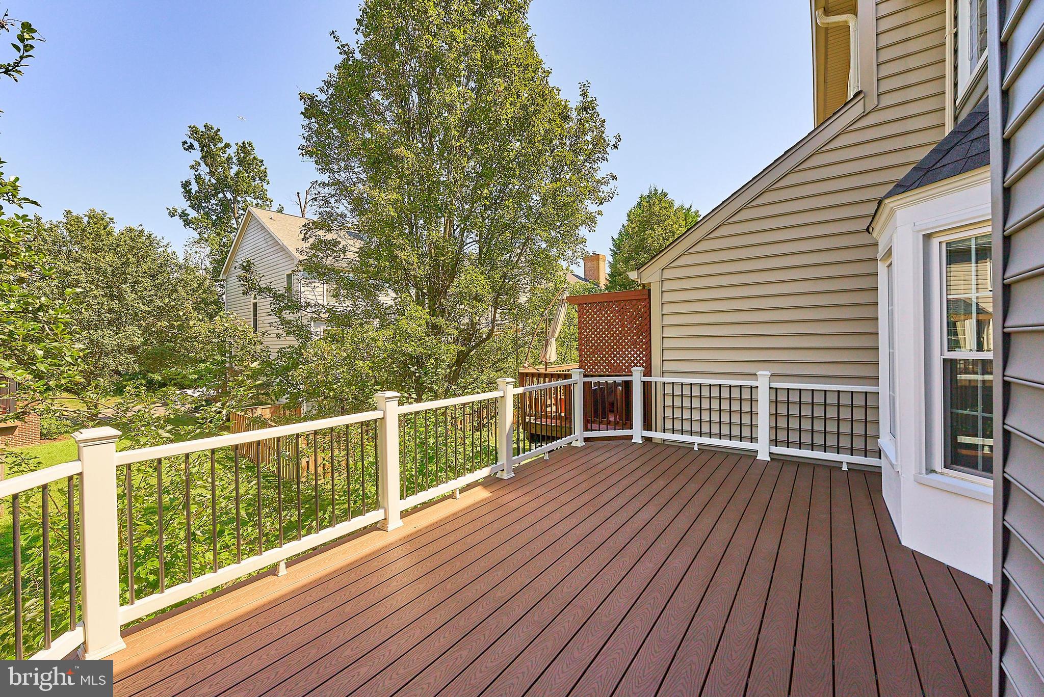 20340 Brentmeade Terrace Sterling, VA 20165 - Photo 6 of 43 a view of a wooden deck with a yard