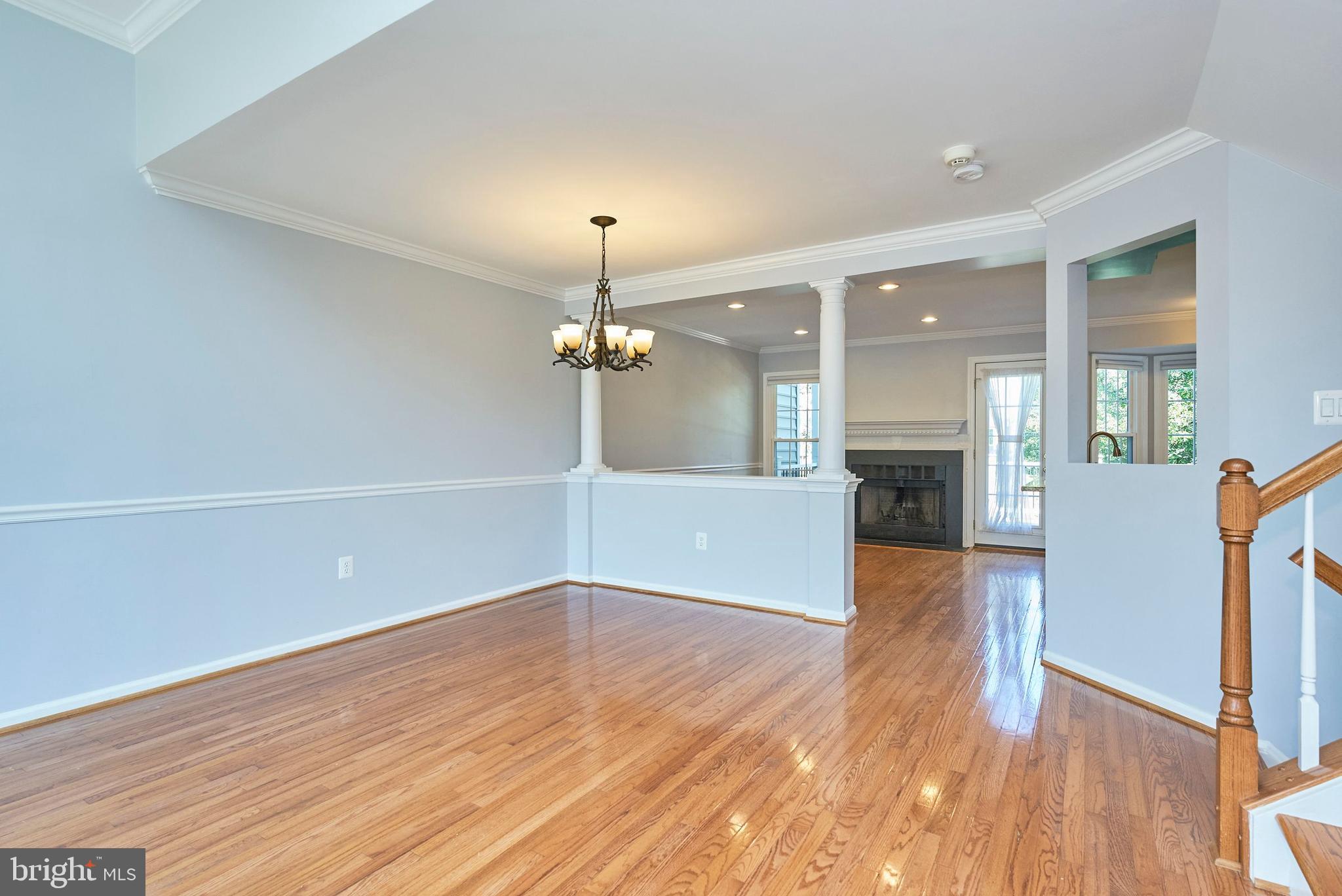 20340 Brentmeade Terrace Sterling, VA 20165 - Photo 7 of 43 a view of a big room with wooden floor a fireplace and windows