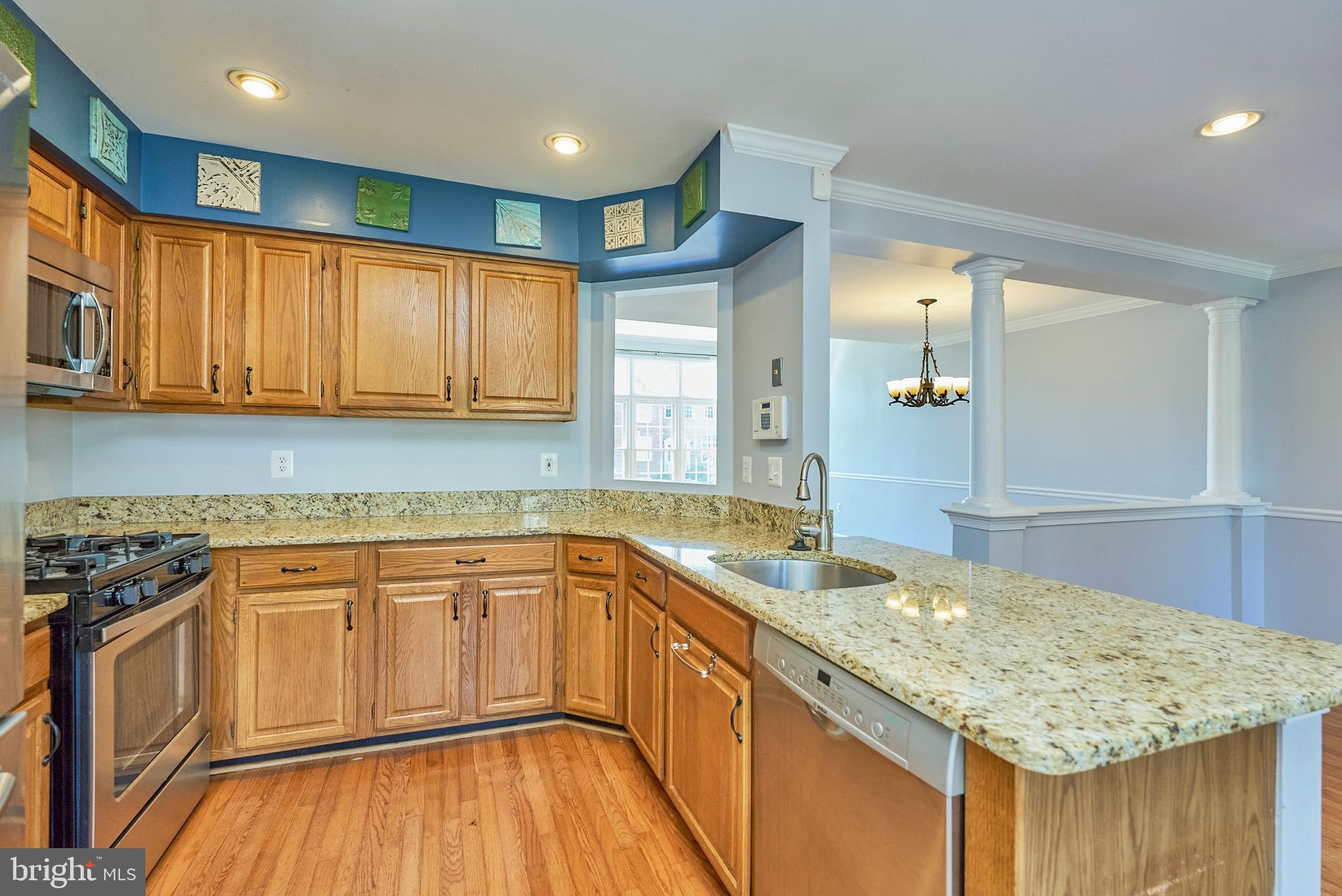 20340 Brentmeade Terrace Sterling, VA 20165 - Photo 9 of 43 a kitchen with a sink stove and cabinets