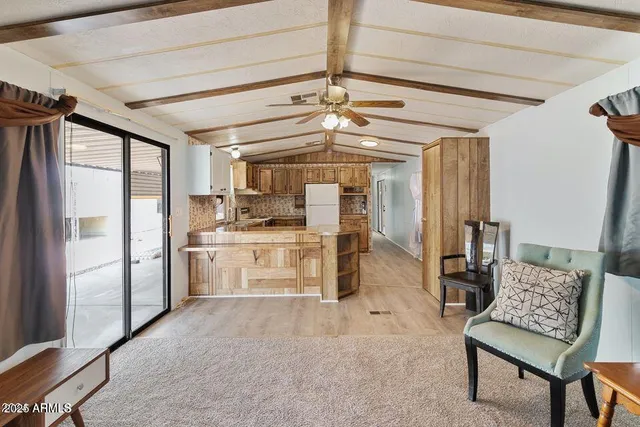 a kitchen with a refrigerator and white cabinets