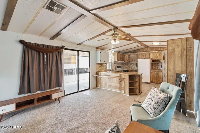 a kitchen with furniture and a window