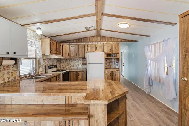 a kitchen with stainless steel appliances granite countertop a sink and refrigerator