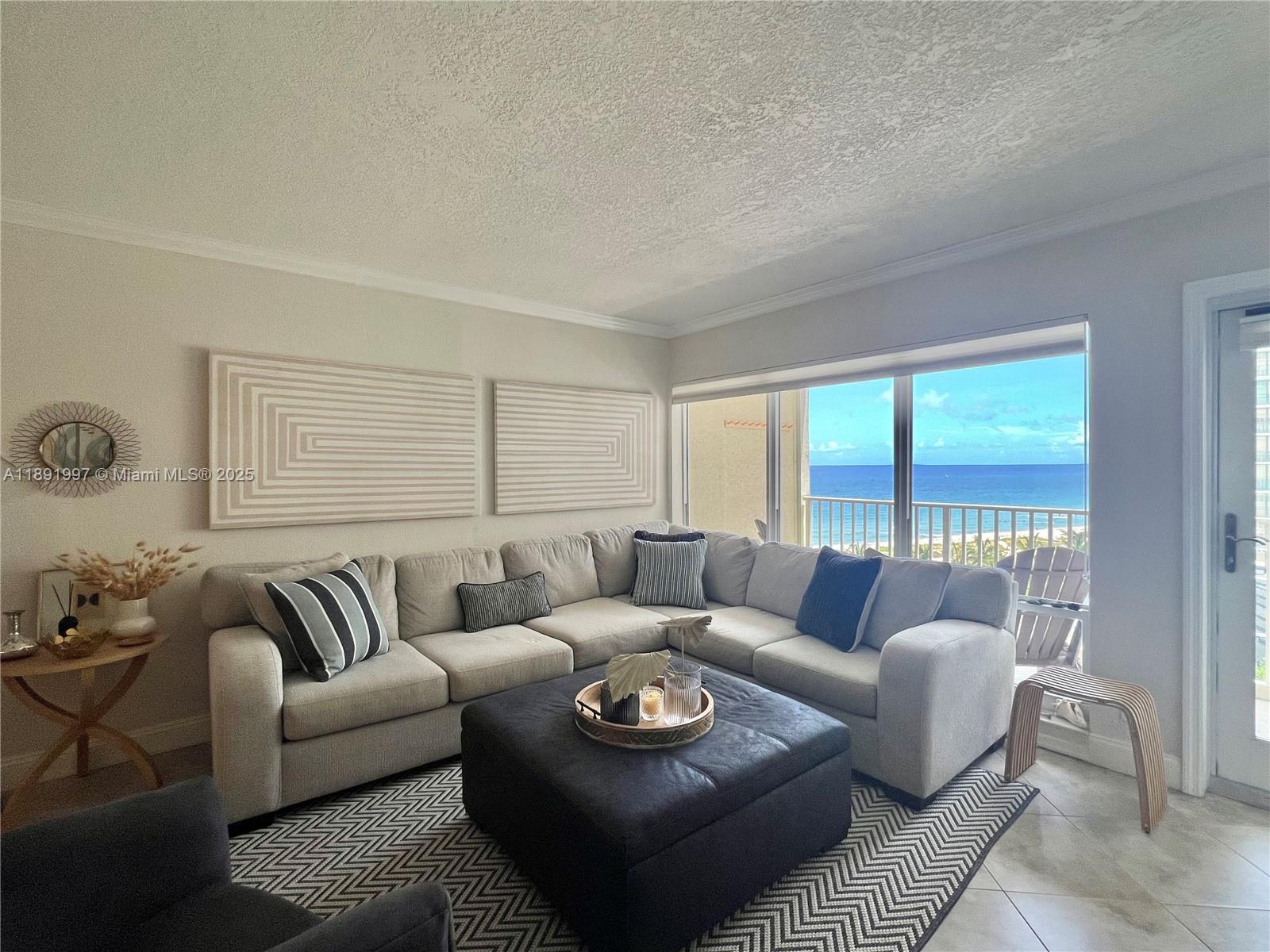 750 North Ocean Boulevard, Unit 905 Pompano Beach, FL 33062 - Photo 12 of 29 a living room with furniture and a large window