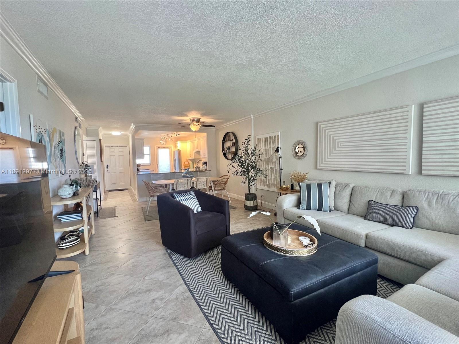 750 North Ocean Boulevard, Unit 905 Pompano Beach, FL 33062 - Photo 15 of 29 a living room with furniture kitchen view and a window