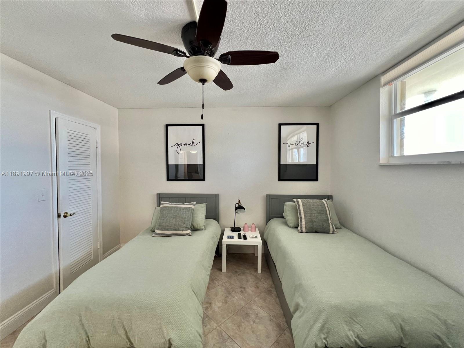 750 North Ocean Boulevard, Unit 905 Pompano Beach, FL 33062 - Photo 17 of 29 a bedroom with a bed and ceiling fan