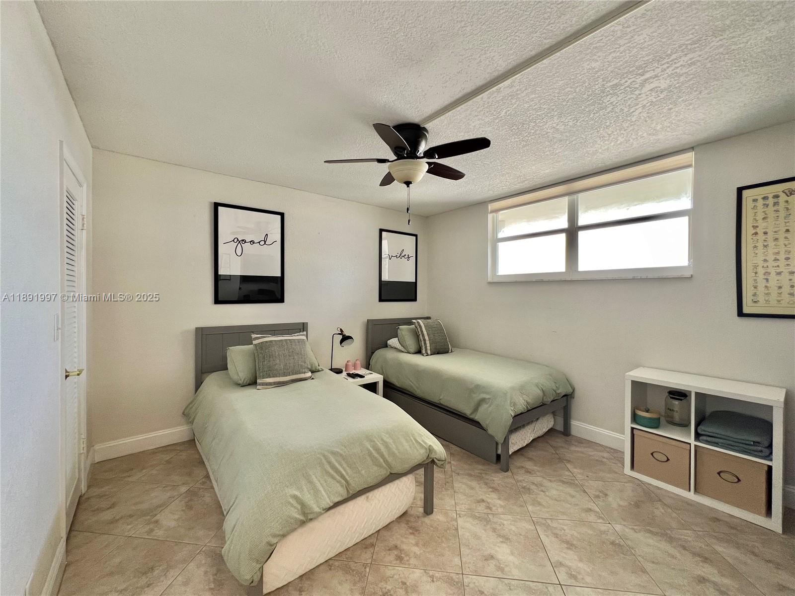 750 North Ocean Boulevard, Unit 905 Pompano Beach, FL 33062 - Photo 18 of 29 a bedroom with two beds and a desk