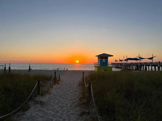a room with pool table and windows