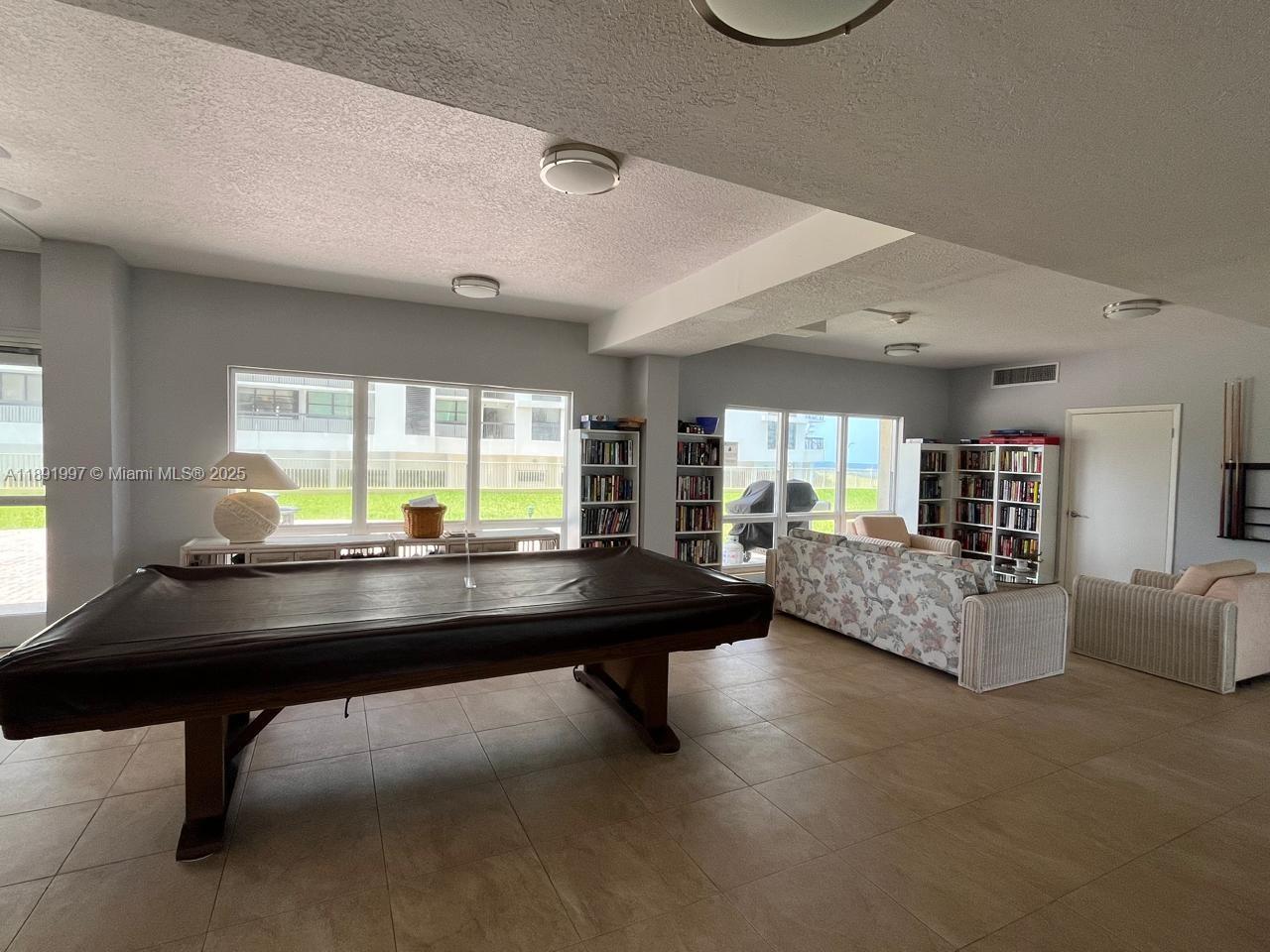 750 North Ocean Boulevard, Unit 905 Pompano Beach, FL 33062 - Photo 27 of 29 a room with pool table and windows