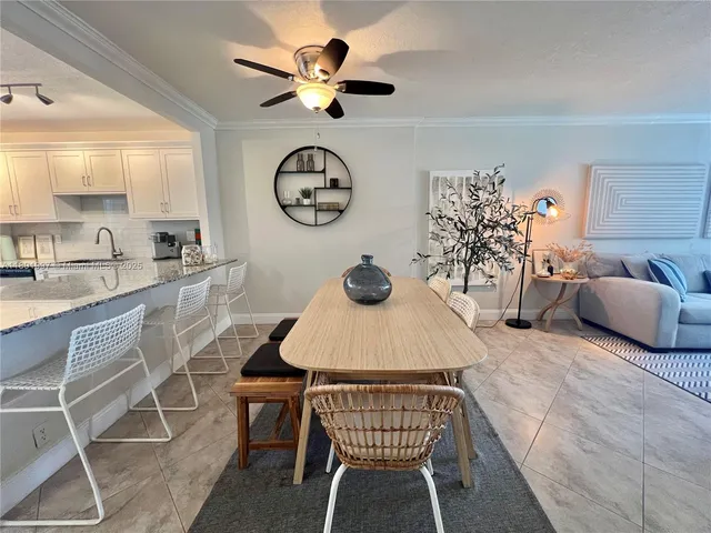 a dining room with furniture and a clock