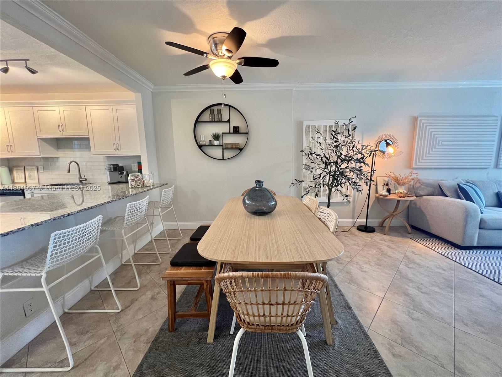 750 North Ocean Boulevard, Unit 905 Pompano Beach, FL 33062 - Photo 8 of 29 a dining room with furniture and a clock
