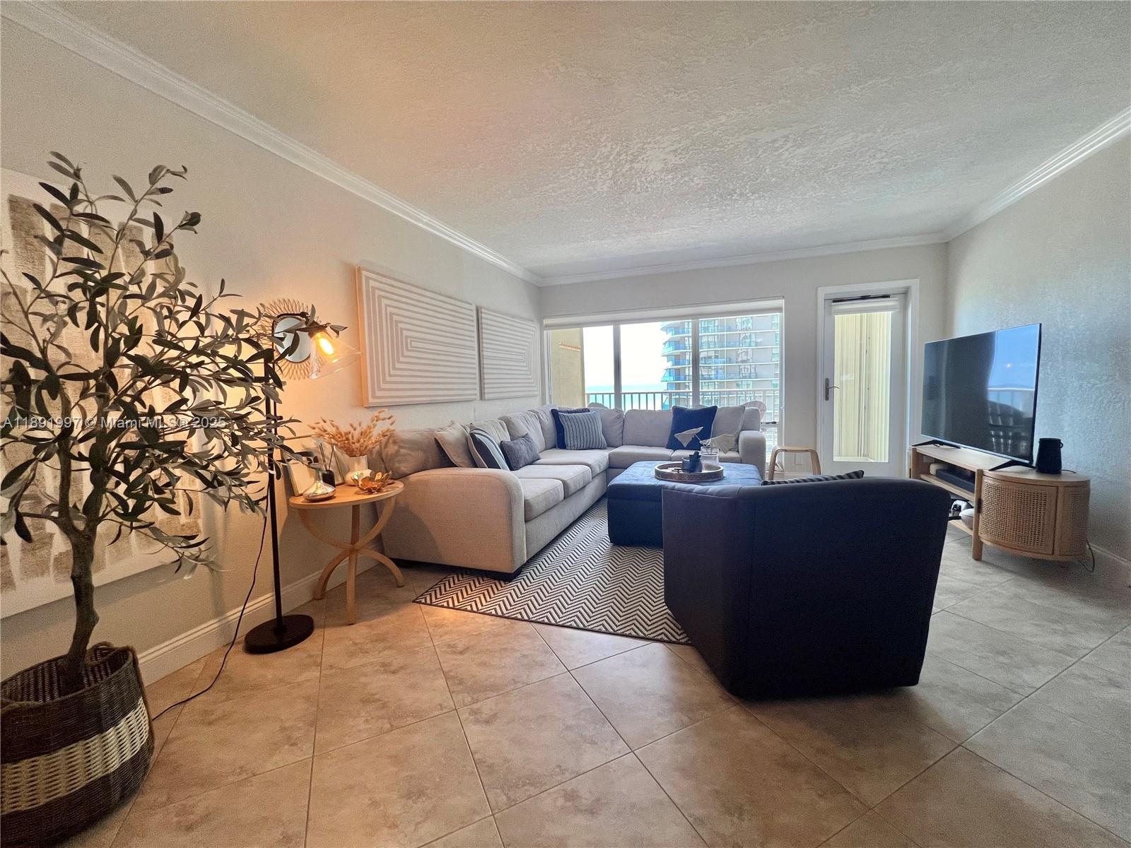 750 North Ocean Boulevard, Unit 905 Pompano Beach, FL 33062 - Photo 10 of 29 a living room with furniture and a potted plant