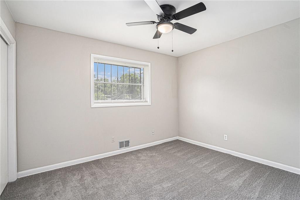2403 Tiffany Place Decatur, GA 30035 - Photo 20 of 29 an empty room with a window and a fan