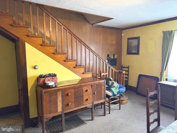 a view of a dining room with furniture and a window