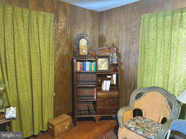 a view of a livingroom with furniture and a mirror